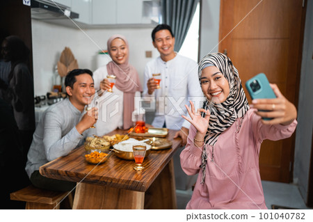 friends taking their picture together using a smartphone 101040782