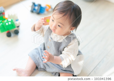 Baby's pretend play, child development, hello, play with building blocks as if they were telephones Baby's pretend play, child development, hello, play with building blocks as if they were telephones 101041396