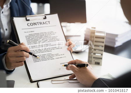 Real estate broker agent presenting and consult to customer to decision making sign insurance form agreement, home model, concerning mortgage loan offer. Real estate broker agent presenting and consult to customer to decision making sign insurance form agreement, home model, concerning mortgage loan offer. 101041817