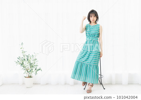 Angry young woman sitting by the window 101042004