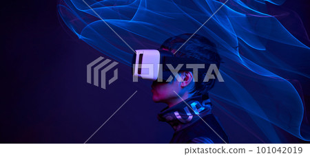 Man is using virtual reality headset to access in metaverse. 101042019