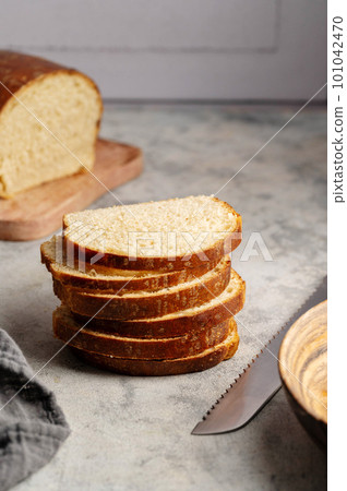 Closeup bread stack of bread slices. Sandwich sourdough loaf bread cut in slices. 101042470
