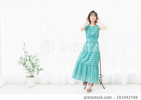 坐在窗邊聽的年輕女人 101042598