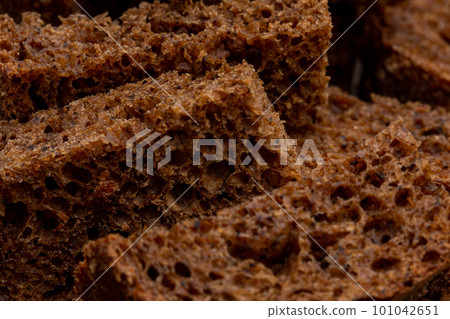 Rye croutons close-up, bread texture, macro photography Rye croutons close-up, bread texture, macro photography 101042651