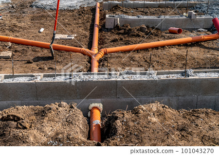 plastic pipe for sewage network in the base plate at the construction site plastic pipe for sewage network in the base plate at the construction site 101043270