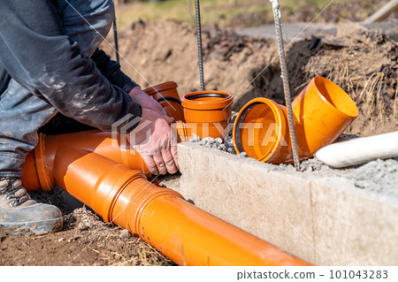 installation of a sewage plastic pipe during the construction of a house 101043283