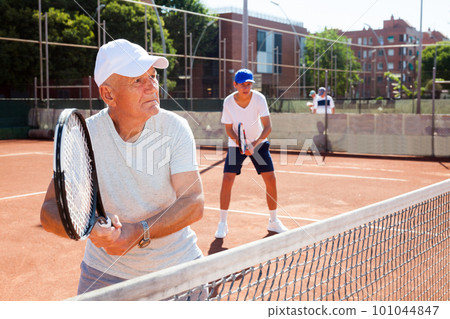 grandfather and grandson playing tennis court grandfather and grandson playing tennis court 101044847