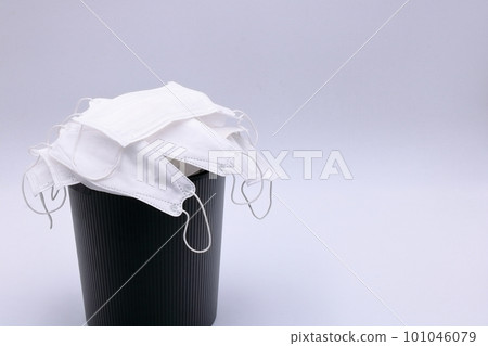 Image of a trash can full of disposable masks (non-woven mask and trash can) Image of a trash can full of disposable masks (non-woven mask and trash can) 101046079