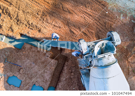 There is concrete mix that is used mix truck during construction of house cement concrete to foundation pads. There is concrete mix that is used mix truck during construction of house cement concrete to foundation pads. 101047494