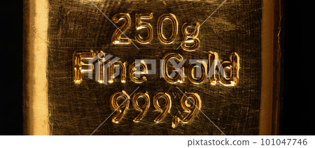 Stamped writing on a cast gold bar, also known as gold bullion. Refined metallic gold, produced by by pouring molten metal into a bar-shaped mold. 250 gram fine gold, equal to 8.04 troy ounces. Photo. Stamped writing on a cast gold bar, also known as gold bullion. Refined metallic gold, produced by by pouring molten metal into a bar-shaped mold. 250 gram fine gold, equal to 8.04 troy ounces. Photo. 101047746