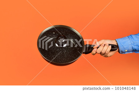 Enameled cast iron cooking vessels. Saucepan glass lid. Nonstick pan coated polytetrafluoroethylene teflon. Man hold new brand pan. Shop buy kitchen goods. Shopping kitchenware. Cooking utensils 101048148