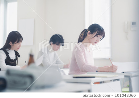 Candidates in plain clothes taking an exam 101048360