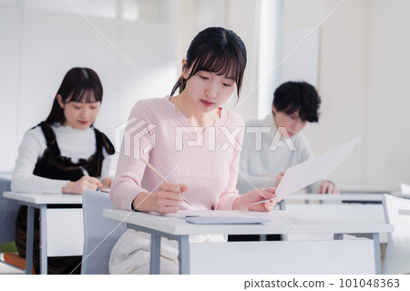 Candidates in plain clothes taking an exam Candidates in plain clothes taking an exam 101048363