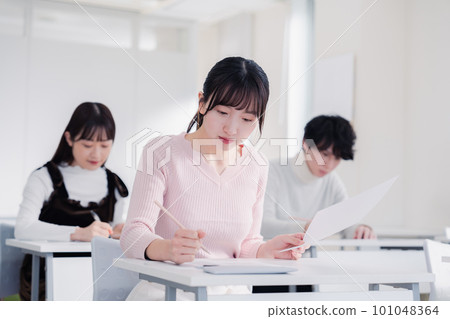 Candidates in plain clothes taking an exam Candidates in plain clothes taking an exam 101048364