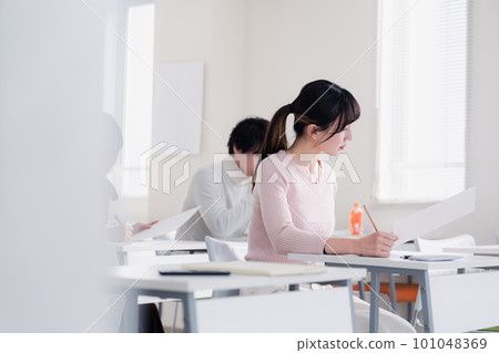 Candidates in plain clothes taking an exam Candidates in plain clothes taking an exam 101048369