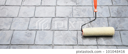 Workers are applying waterproofing with a brush. The roof system of a high-rise building 101048416