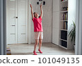 Child warms up before training at home. 101049135