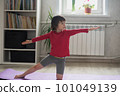 Child doing sports in the room at home 101049139