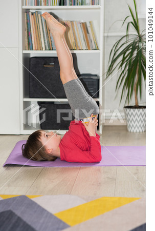 Child exercising at home. Physical and mental health trend 101049144
