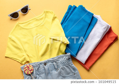 denim shorts and various colorful t-shirts, sunglasses. fashion dress 101049515