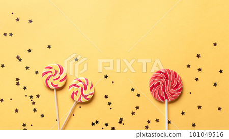 festival or birthday background with lollipops and shining sparkles. 101049516