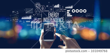 Energy Independence concept with person using a smartphone at night Energy Independence concept with person using a smartphone at night 101049768