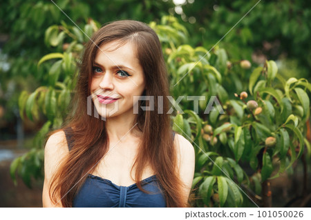 Portrait of pretty girl. Happy young woman enjoying sunset in nature. 101050026