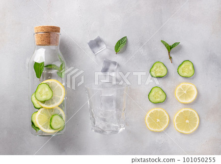 glass bottle with infused water with lemon, cucumber, mint glass bottle with infused water with lemon, cucumber, mint 101050255