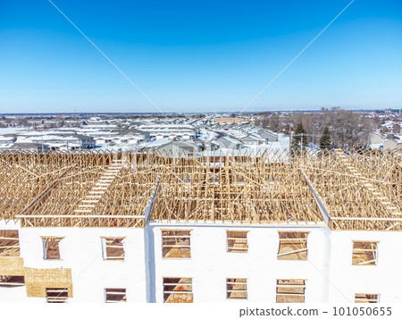 Aerial drone view of a multifamily apartment complex under construction. 101050655