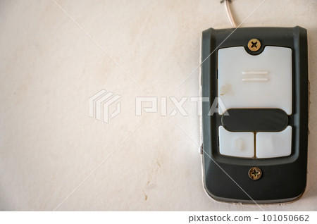 Drywall with a mounted garage door opener control panel. Drywall with a mounted garage door opener control panel. 101050662