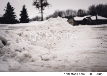 Snowbank at the end of a driveway left after city snowplows cleared a street. Snowbank at the end of a driveway left after city snowplows cleared a street. 101050855