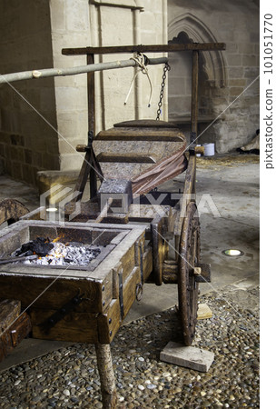 Old wooden chair in a metal basket 101051770