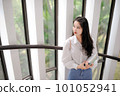 Young Asian woman standing near the glass door 101052941