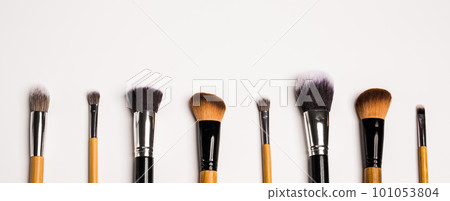 Assorted make up brushes isolated, top view banner. White background with copy space and empty space for text Assorted make up brushes isolated, top view banner. White background with copy space and empty space for text 101053804