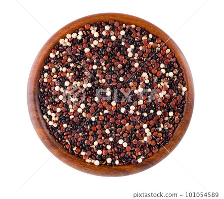 Quinoa seeds in wooden bowl, isolated on white background. Mix of white, red and black quinoa. Top view. 101054589