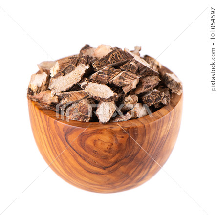 Calamus root in wooden bowl, isolated on white background. Sweet flag, sway or muskrat root. Dry root of Acorus calamus. Calamus root in wooden bowl, isolated on white background. Sweet flag, sway or muskrat root. Dry root of Acorus calamus. 101054597
