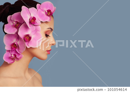 Portrait of beautiful young woman with orchid Portrait of beautiful young woman with orchid 101054614