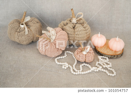 Hobby background with handmade knit pumpkins and white pearl beads. DIY, craft decoration for fall and winter holidays. Hobby background with handmade knit pumpkins and white pearl beads. DIY, craft decoration for fall and winter holidays. 101054757