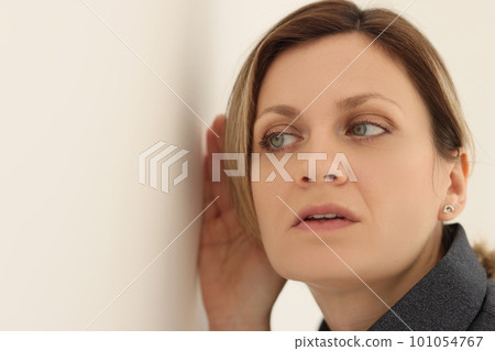 Woman tries to eavesdrop on conversation of colleagues Woman tries to eavesdrop on conversation of colleagues 101054767