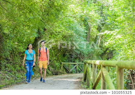 Senda del oso, Teverga Asturias. mixed race travelers couple hiking ecotourism conservation path Senda del oso, Teverga Asturias. mixed race travelers couple hiking ecotourism conservation path 101055325