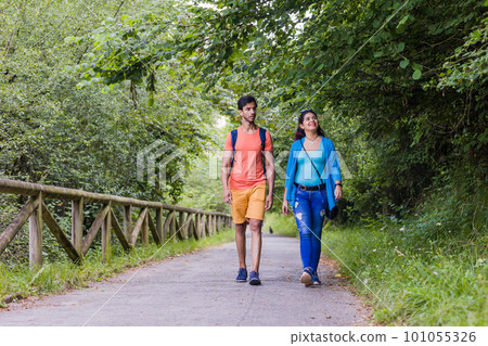 Senda del oso, Teverga Asturias. mixed race travelers couple hiking ecotourism conservation path Senda del oso, Teverga Asturias. mixed race travelers couple hiking ecotourism conservation path 101055326