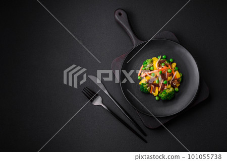 Delicious steamed vegetables broccoli, mushrooms, peas, carrots and onions 101055738