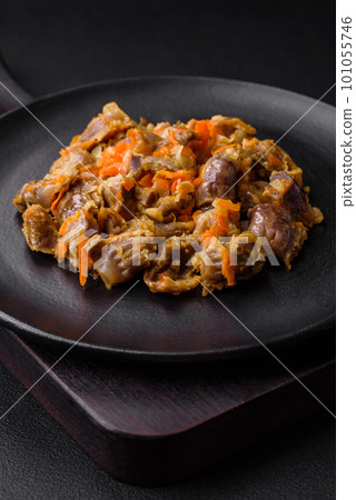 Delicious stewed chicken gizzards with carrots and tomato Delicious stewed chicken gizzards with carrots and tomato 101055746