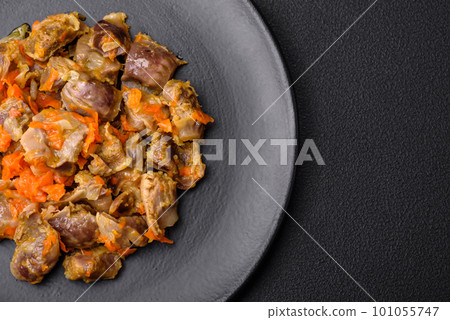 Delicious stewed chicken gizzards with carrots and tomato Delicious stewed chicken gizzards with carrots and tomato 101055747