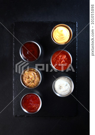 Different sauces. Sauces in the assortment. Sauces for snacks. The concept of the bar. Beer snacks.Flat lay. Top view. Different sauces. Sauces in the assortment. Sauces for snacks. The concept of the bar. Beer snacks.Flat lay. Top view. 101055898