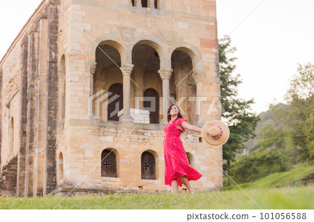 Freedom and success wellbeing getaway. Positive happy dance from latin woman on holiday in Asturias Freedom and success wellbeing getaway. Positive happy dance from latin woman on holiday in Asturias 101056588