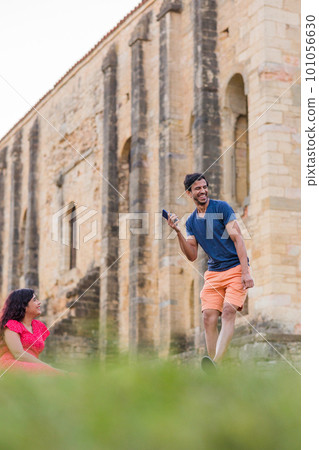 Indian model, mature man dancing Bollywood with smartphone music. Europe travel rhythm on casual. Indian model, mature man dancing Bollywood with smartphone music. Europe travel rhythm on casual. 101056630