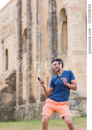 Indian model, mature man dancing Bollywood with smartphone music. Europe travel rhythm on casual. 101056638