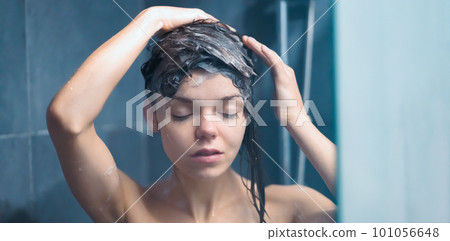 Girl takes a shower, washes her hair. 101056648