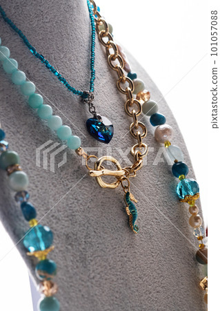 author set with different blue colors necklaces presented on maneken against white background. jewelry and hobby concept. trends2023 author set with different blue colors necklaces presented on maneken against white background. jewelry and hobby concept. trends2023 101057088